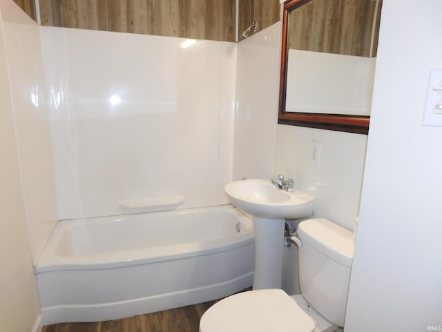 bathroom featuring shower / tub combination, hardwood / wood-style floors, and toilet