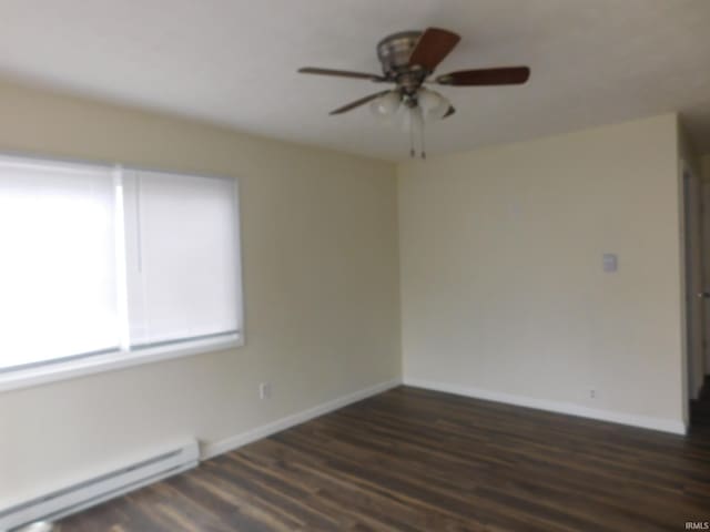 unfurnished room with ceiling fan, dark hardwood / wood-style flooring, and a baseboard radiator