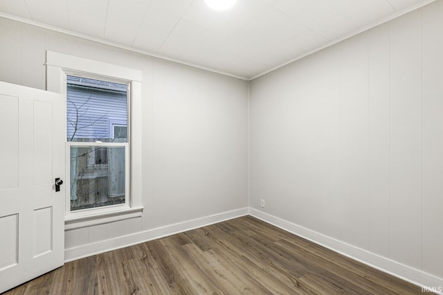 empty room with crown molding and hardwood / wood-style floors