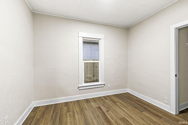 spare room with dark hardwood / wood-style flooring