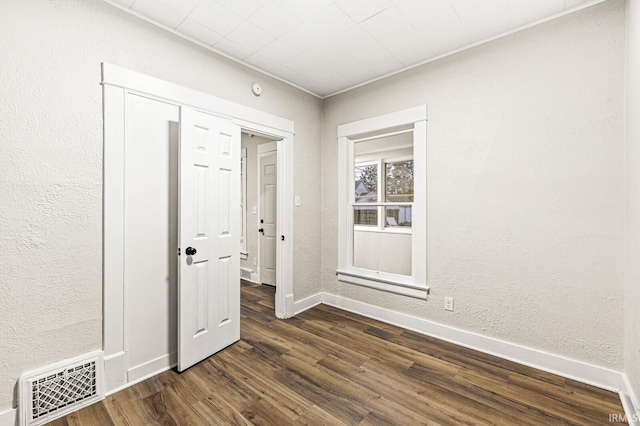 spare room featuring dark hardwood / wood-style floors