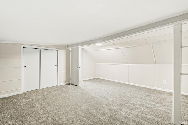 bonus room featuring light colored carpet and lofted ceiling