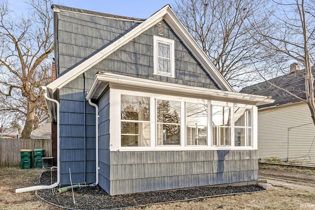 view of home's exterior with a sunroom