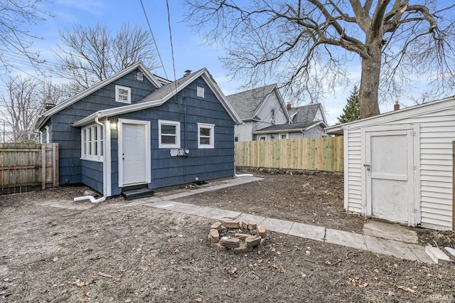 back of property featuring a shed