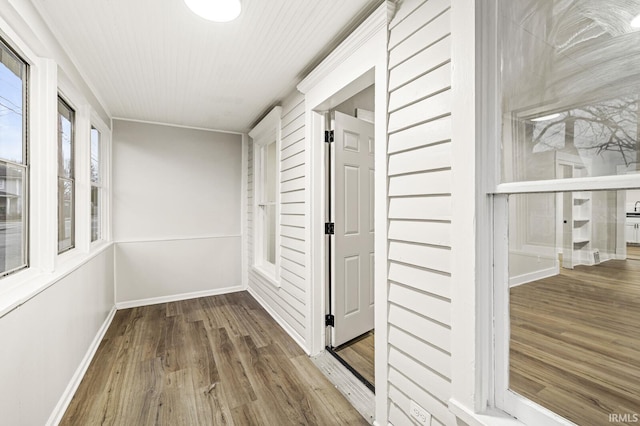 hallway with hardwood / wood-style flooring