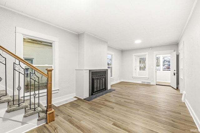 living room featuring light wood-type flooring and ornamental molding