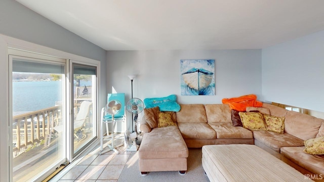 living room featuring a water view and light tile patterned flooring