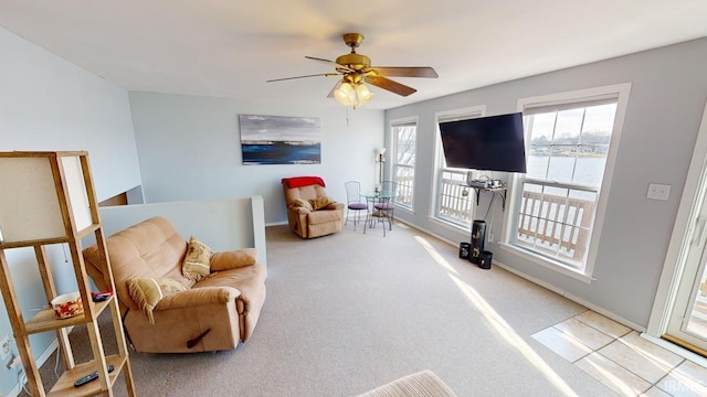 living area featuring ceiling fan and light colored carpet