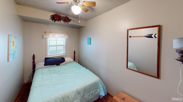 bedroom with a textured ceiling and ceiling fan