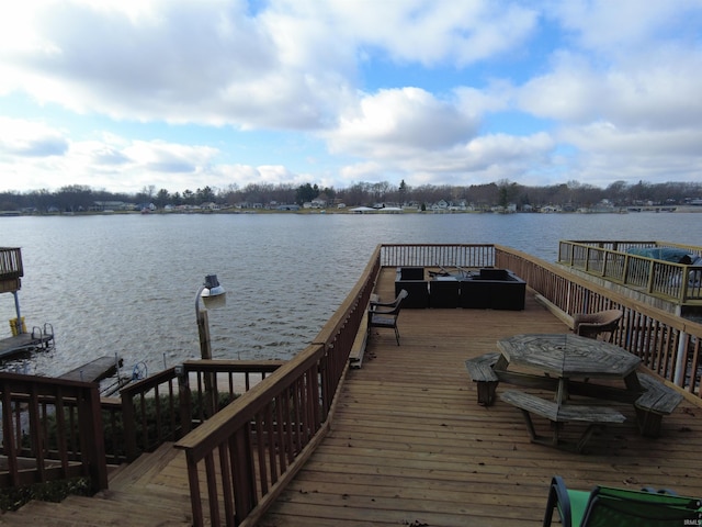 dock area featuring a deck with water view