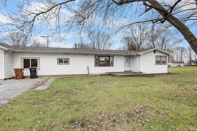 rear view of house featuring a yard