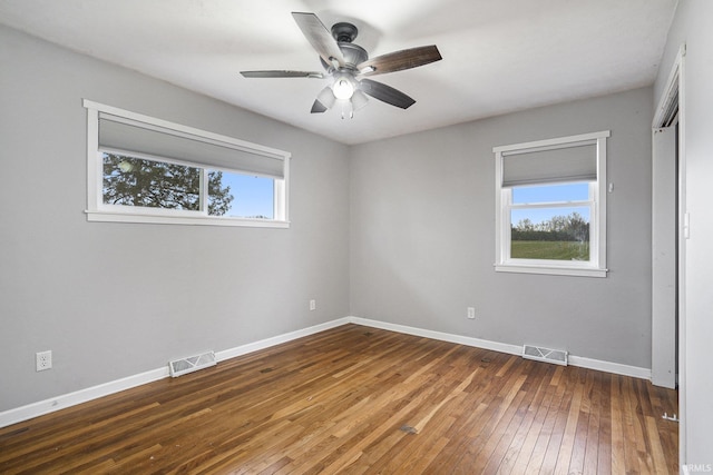 spare room featuring ceiling fan and dark wood-type flooring