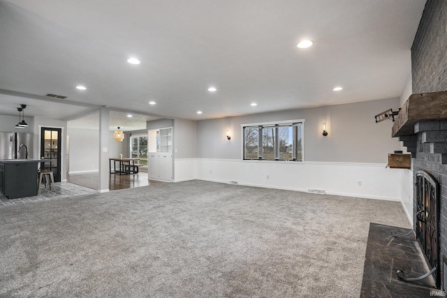 carpeted living room featuring a fireplace