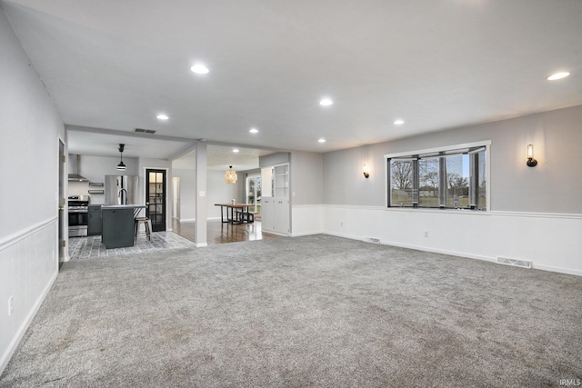 unfurnished living room featuring carpet