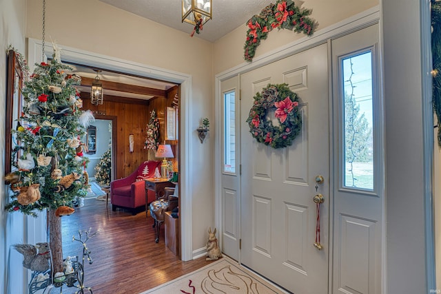 entryway with plenty of natural light, wood-type flooring, and a textured ceiling