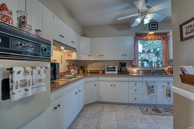 kitchen with white gas cooktop, white cabinets, oven, sink, and ceiling fan