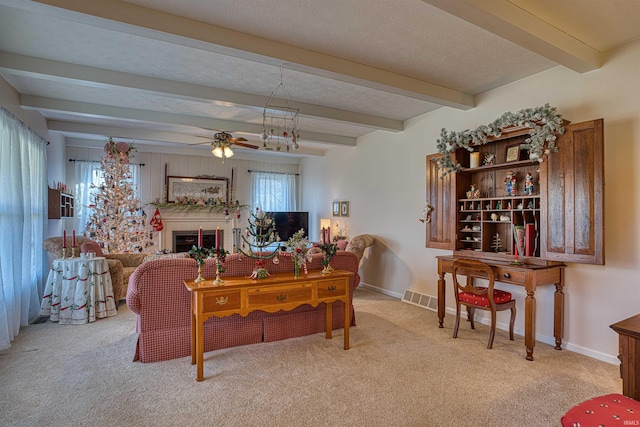 living room with beamed ceiling, light carpet, and ceiling fan