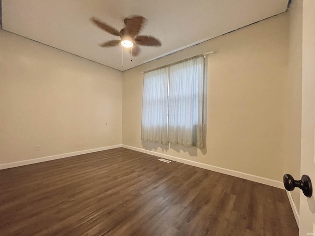 spare room with ceiling fan and dark wood-type flooring