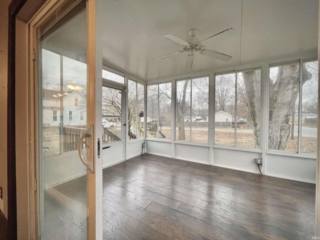 unfurnished sunroom with ceiling fan and a healthy amount of sunlight