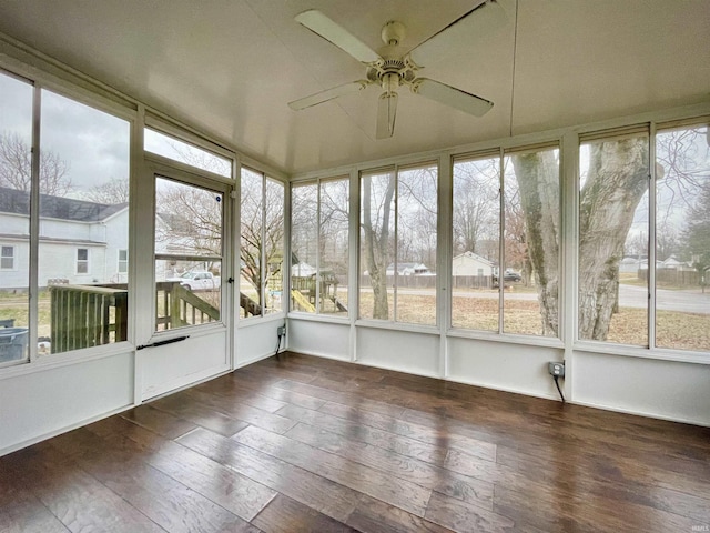 unfurnished sunroom featuring ceiling fan