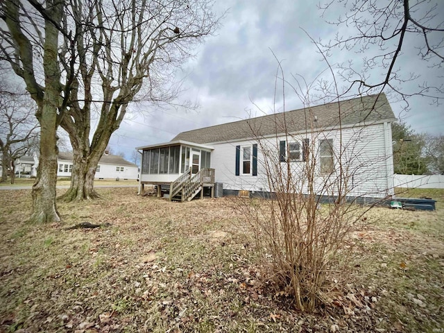 back of property with a sunroom and cooling unit