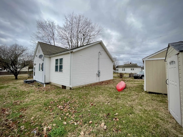 view of property exterior with a lawn and a storage shed