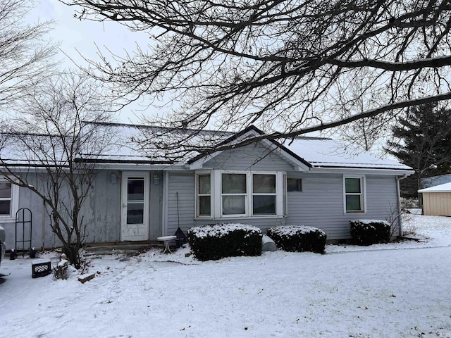 view of snow covered back of property