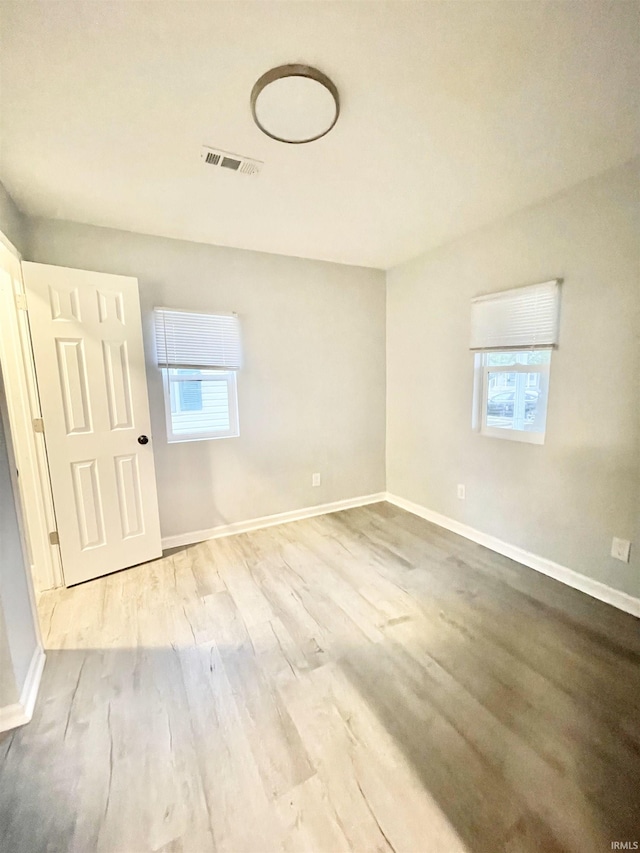 spare room featuring hardwood / wood-style floors