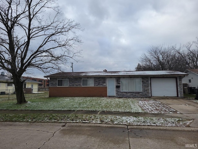 ranch-style home with a front yard and a garage