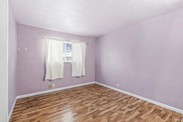 spare room with hardwood / wood-style floors