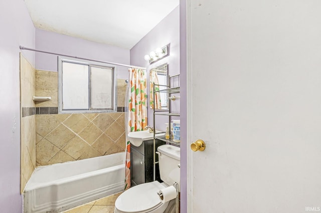 full bathroom featuring tile patterned floors, sink, shower / bath combo with shower curtain, and toilet