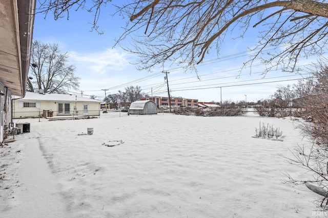 snowy yard with central AC