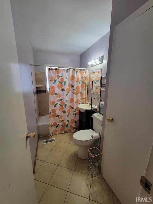 full bathroom featuring toilet, shower / bath combo, vanity, and tile patterned floors