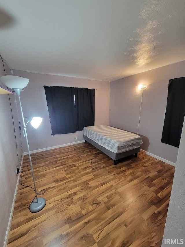 unfurnished bedroom with hardwood / wood-style floors