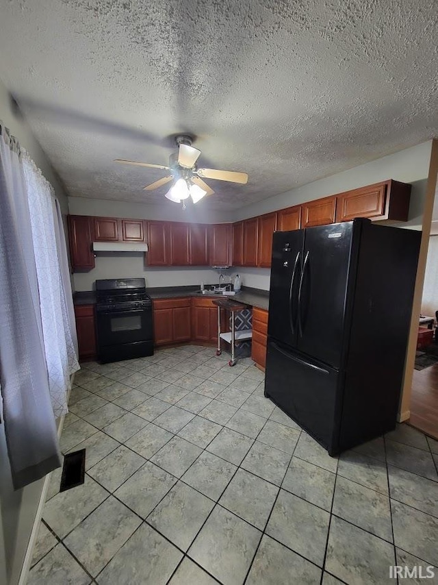 kitchen with light tile patterned flooring, sink, ceiling fan, and black appliances