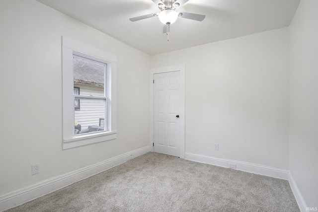 spare room featuring carpet flooring and ceiling fan