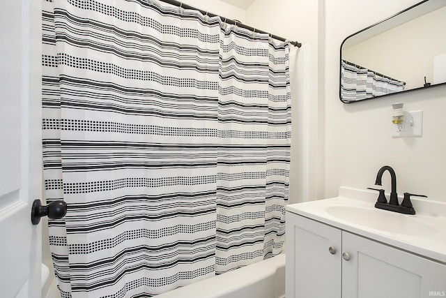 bathroom featuring shower / bath combo and vanity