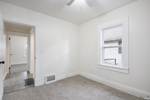 carpeted empty room featuring ceiling fan