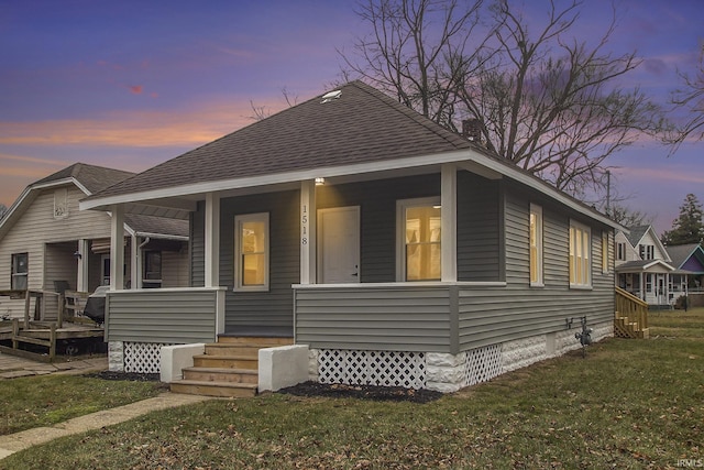 view of front of home with a lawn and a porch