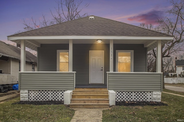 view of front of house featuring a lawn and a porch