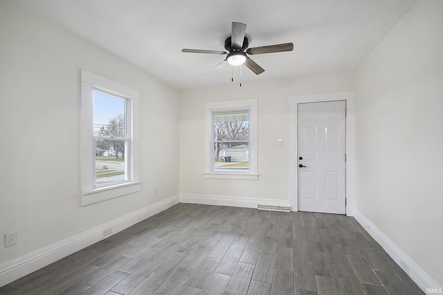 empty room featuring ceiling fan and dark wood-type flooring