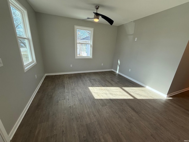 unfurnished room with dark hardwood / wood-style flooring and ceiling fan