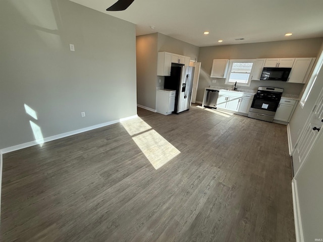 kitchen featuring dark hardwood / wood-style flooring, white cabinetry, sink, and appliances with stainless steel finishes