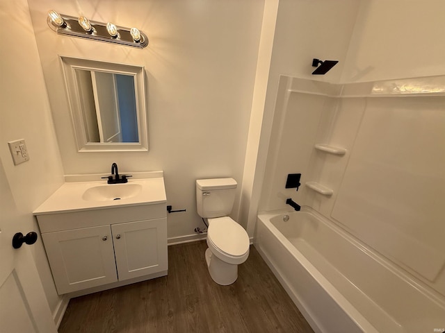 full bathroom with washtub / shower combination, vanity, wood-type flooring, and toilet