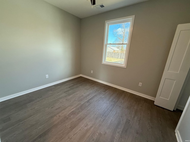 empty room with dark wood-type flooring