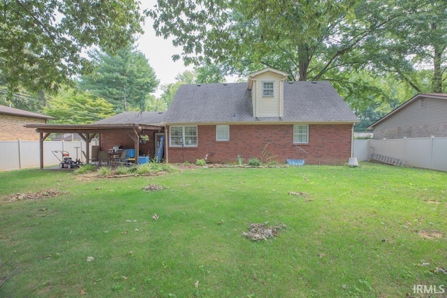 back of property featuring a fenced backyard, a patio, a lawn, and brick siding