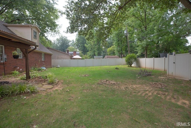 view of yard with a fenced backyard