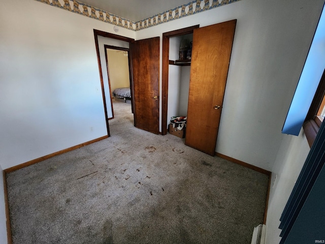 unfurnished bedroom with a closet and light colored carpet