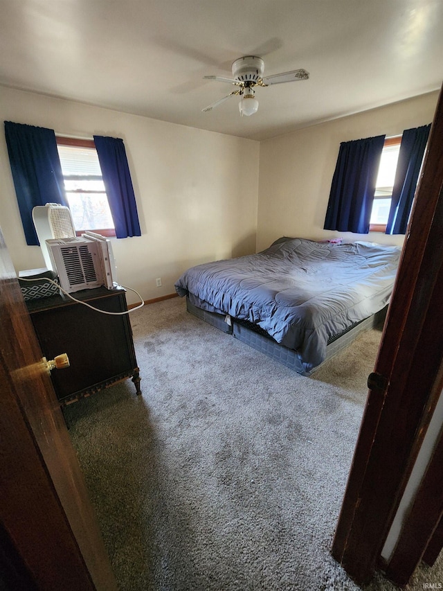 carpeted bedroom with ceiling fan and multiple windows