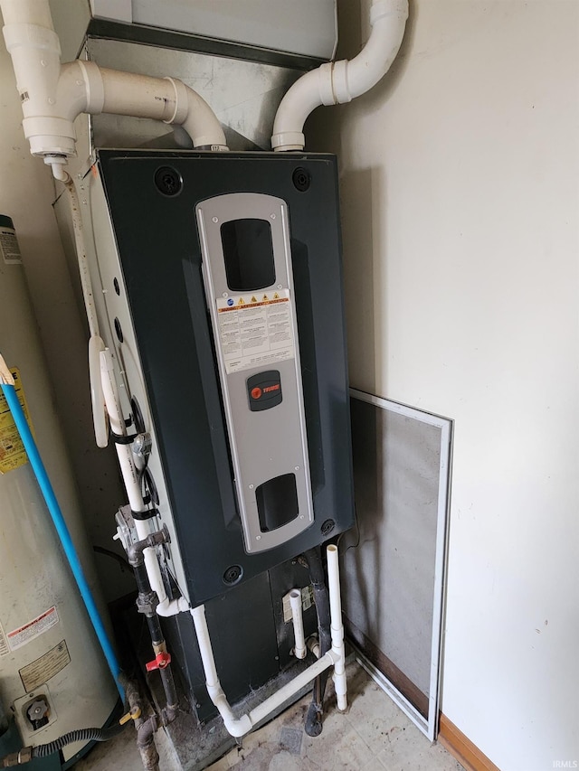 utility room featuring gas water heater